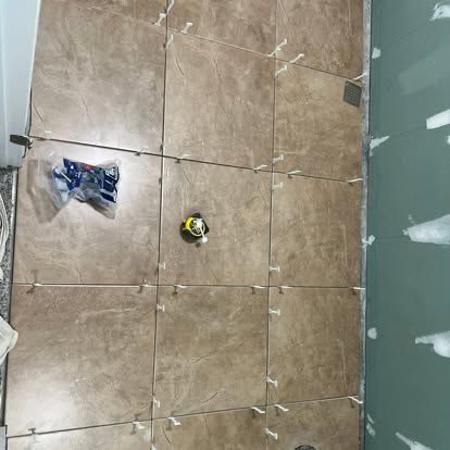 Large-format tile floor installation in progress